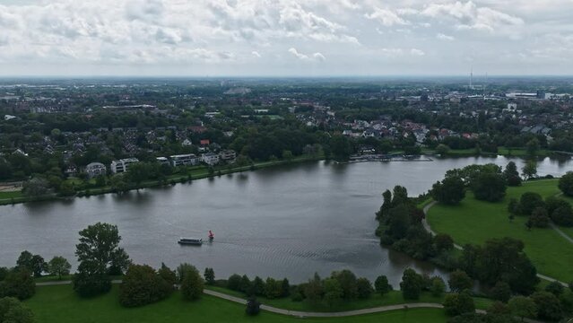 An aerial drone view of Aasee Lake in M&uuml;nster . Lake Aasee is an artificial lake located in M&uuml;nster , Germany .