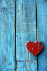 Red heart shape on blue wooden background. Perfect for Valentine's Day