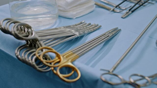 Close-up view of medical surgical table with instruments, doctor preparing instruments for surgery in clinic in operating room