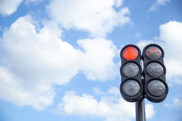 the traffic light in the background of blue sky, red light