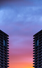 gradient color sky with building silhouette, pink, orange, blue, background