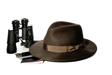men's wide brimmed high crowned sable fedora hat and binoculars and a money case and a passport isolated on a white backgroun - Powered by Adobe
