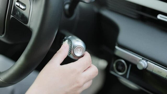Shifting automatic transmission from P parking to D drive mode. Driver In Auto Gear Lever Drive Mode. The driver's hand moved the gear selector to the reverse R mode in the electric car