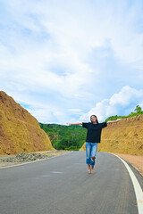 Portrait of an Asian girl on a mountain road