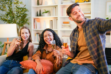 Friends captured mid-laughter as they toast in a stylish home, taking a selfie to remember the cheerful occasion