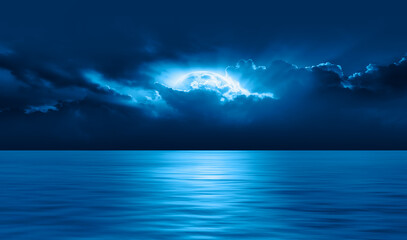 Night sky with blue moon in the clouds over the calm blue sea, many sytars in the background ...