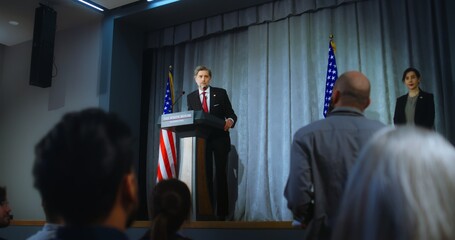 Presidential of USA candidate delivers campaign speech, answers questions, gives interview. American republican politician performs at meeting with press. Election day. Backdrop with American flags. - obrazy, fototapety, plakaty