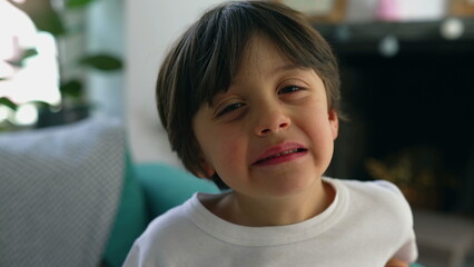 Tired little boy yawning to camera, close-up face of 5 year old child portrait feeling exhausted...