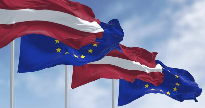 Flags of Latvia and the European Union waving on a clear day