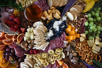 Closeup of a Charcuterie Board with a mixture of fruits, vegetables, meats and cheeses.