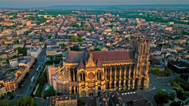 Gothic cathedral with twin towers at golden sunset in France. Reims city situated in a vine-growing country in which champagne wine is produced. Aerial view Cathedral of Notre-Dame of Reims, France.