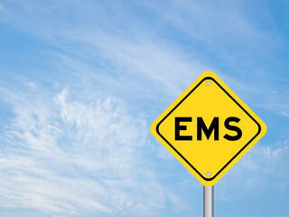Yellow transportation sign with word EMS (abbreviation of emergency medical services or express mail service) on blue color sky background