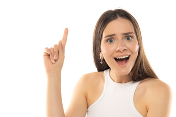 Portrait of young happy teenage girl with idea and finger up on white background