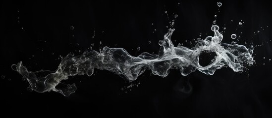 Smoke and water in motion on dark backdrop