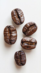 Close-up of roasted coffee beans on a white background