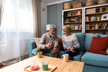 Senior couple, simple living. Older people man and woman full of love and respect, sitting at cozy...