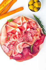 Charcuterie board. Antipasti appetizers of meat platter with salami, prosciutto crudo or jamon and olives. 