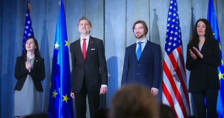 European Union representative and mature president of the United States together shake hands after...