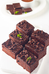Delicious chocolate brownies with mint on white background. Sweet cake concept. 