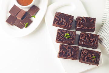 Delicious chocolate brownies with mint on white background. Sweet cake concept. 