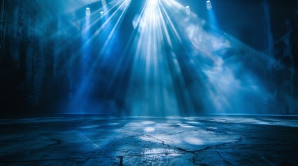 Blue spotlights illuminate an empty stage.
