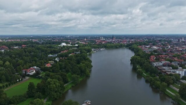 An aerial drone view of Aasee Lake in M&uuml;nster . Lake Aasee is an artificial lake located in M&uuml;nster , Germany .