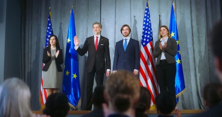 World leaders during meeting with journalists. European union representative and mature president of the United States together shake hands after press conference. Backdrop with American and EU flags. - obrazy, fototapety, plakaty