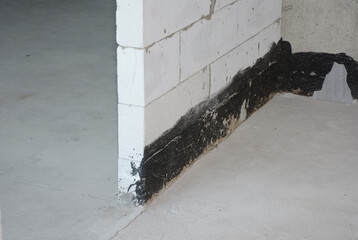 Close up on wall bitumen waterproofing indoors