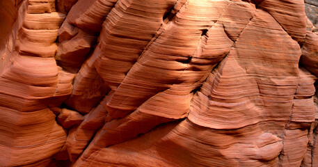 Wave-shaped rocks in a slot canyon in the desert near Page in Arizona, USA. Red sandstone washed...