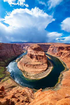 Horseshoe Bend is a meander of Colorado River near Page, Arizona, USA and part of Grand Canyon. Panoramic wide angle view of river loop and colorful red sandstone. Major sight on a sunny spring day.