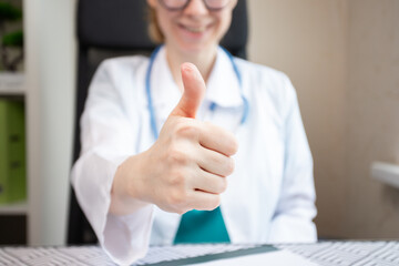 Doctor thumbs up, health specialist signaling good news, medical satisfaction.