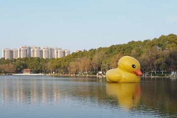 Giant inflatable yellow duck floating on the water in a lake park in Xiantao, China