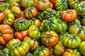 Beefsteak tomatoes in different colors for sale at a market