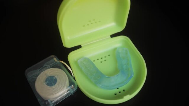 Dental floss and mouthguard for teeth on dressing table. Dental healthcare and Orthodontic concept.