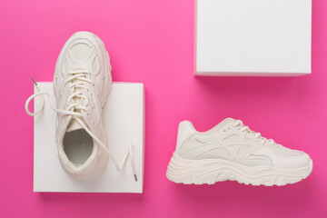 White woman trendy sneakers on concrete background