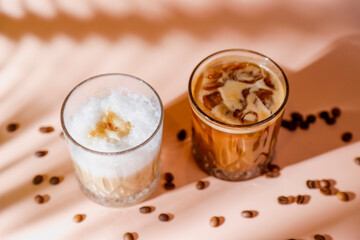 Obraz na płótnie Canvas Ice coffee in a tall glasses with coffee beans around.