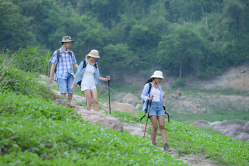A group of friends going hiking in the streams of the tropical forest area.