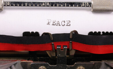 Typed PEACE inscription in black ink on paper with an old typewriter