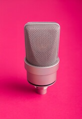 Microphone for a podcast on a colored background.