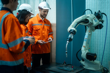 A group of Robotics engineers working with Programming and Manipulating Robot Hand, Industrial...