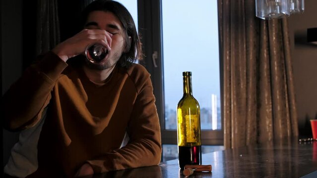 A man drinks red wine and ignores his girlfriend, who is angry with him because of his drinking problem. Mid shot. Slow motion. 4k