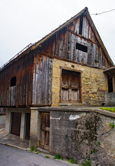 Fototapeta na wymiar An old and now disused farming building in village of Ovaro in Udine Province, Friuli-Venezia Giulia, north east Italy
