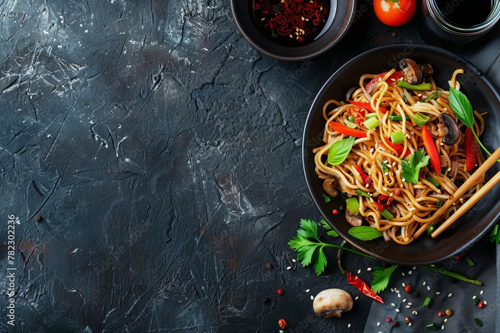 Poster asian noodles with veggies mushrooms soy sauce top view with dark background and space for text