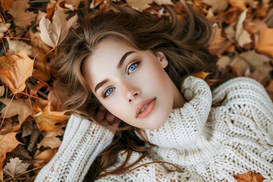 Young Woman Laying on Top of Pile of Leaves