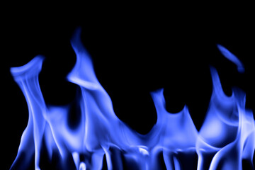 Blurred image of blue flames on a black background.