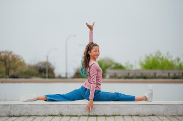 Portrait of a girl doing rhythmic gymnastics outdoors.