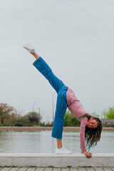 Portrait of a girl doing rhythmic gymnastics outdoors.