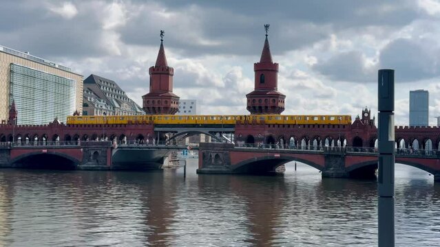 yellow subway train crossing oberbaum Bridge in Berlin, Germany