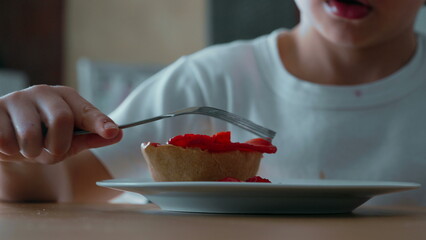 Child Struggling to Reach Cheesecake with Fork - Close-Up View of Sugary Treat Topped with...
