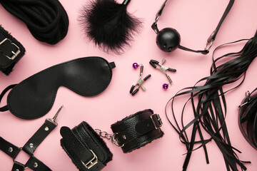 Set of erotic toys for BDSM on pink background. The game of sexual slavery with a whip, gag and leather blindfold. Intimate sex games - obrazy, fototapety, plakaty